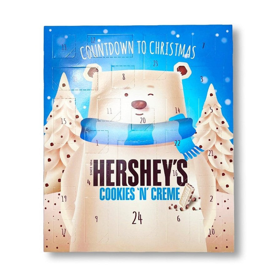 Un paquet bleu sur fond blanc avec un immense ours blanc qui fait un clin d’oeil et entouré de 2 sapins blanc. Chaque case à son nombre et sa forme