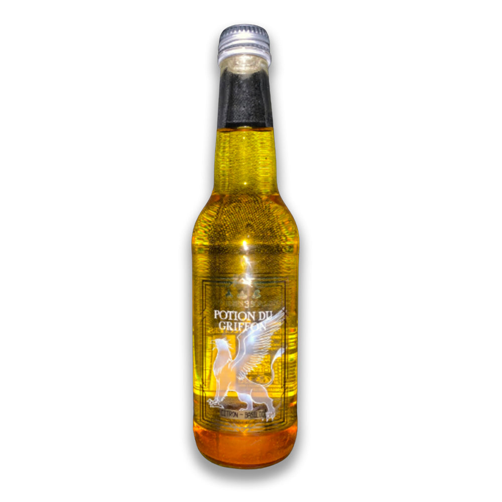 Une bouteille transparente avec une boisson pailletée jaune et sur l’étiquette une créature blanche avec des ailes et une queue. Le tout sur fond blanc