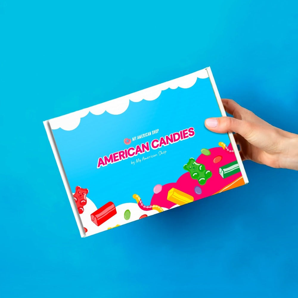 Un carton bleu et blanc avec des dessins de bonbons très colorés, le tout sur fond bleu